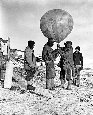 Dr George C. Simpson inflating meteorological balloon