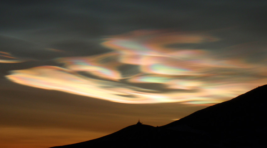 Cold temperature nacreous clouds are lit up by the sunrise at McMurdo, Antarctica