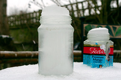 Ice expanded as it froze popping the lids off these jars of water