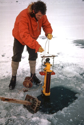 Barry Heywood lowering a water sampling device