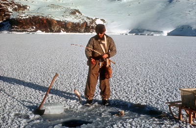 Doug Bone line-fishing through hole in sea ice - 1967-68