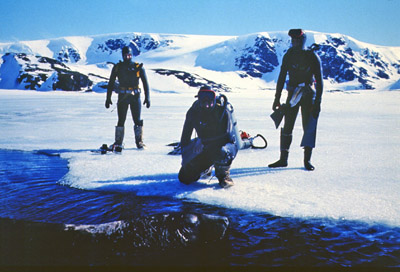 Three divers at edge of fast ice winter