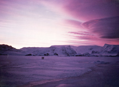 Walking out on the sea ice deep purple lenticular sky